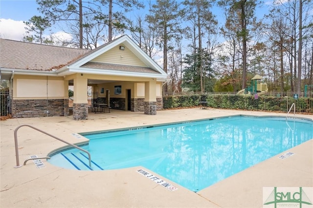 view of swimming pool with a patio area