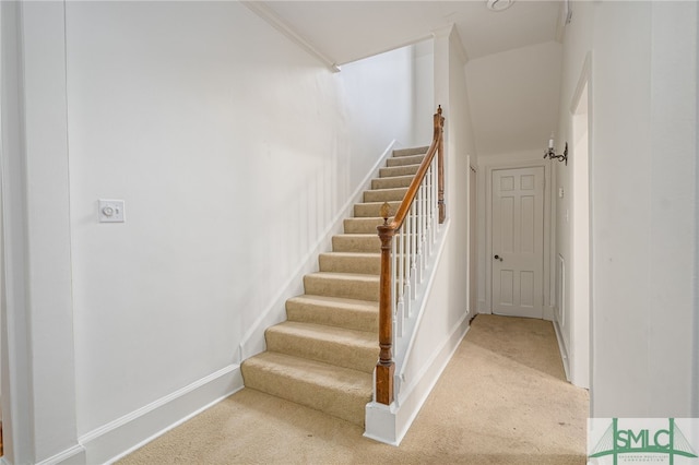 staircase with baseboards and carpet flooring