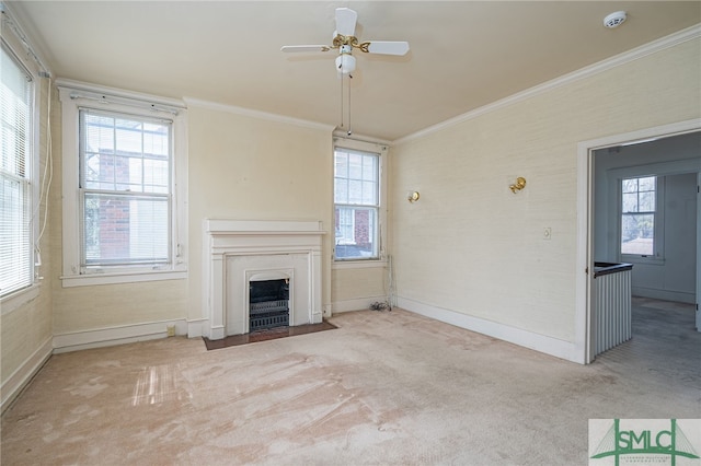 unfurnished living room featuring a fireplace with flush hearth, carpet, baseboards, and ornamental molding