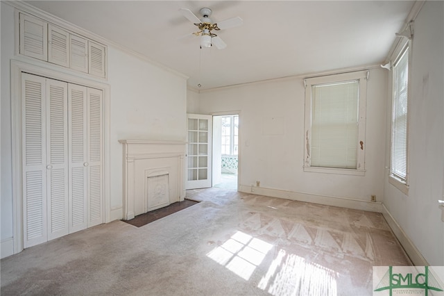 interior space featuring crown molding, a ceiling fan, and baseboards