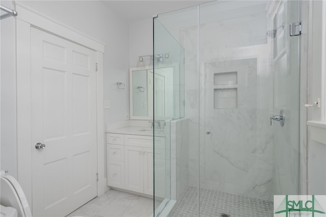 full bath featuring vanity, marble finish floor, and a marble finish shower