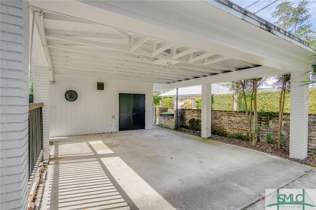 view of patio with driveway and fence