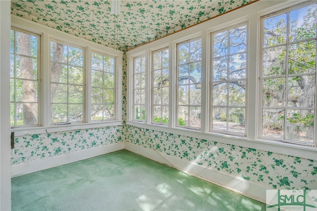 unfurnished sunroom featuring a wealth of natural light