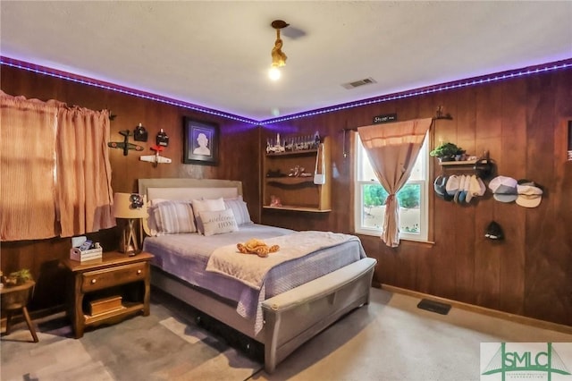 bedroom with carpet flooring and wooden walls