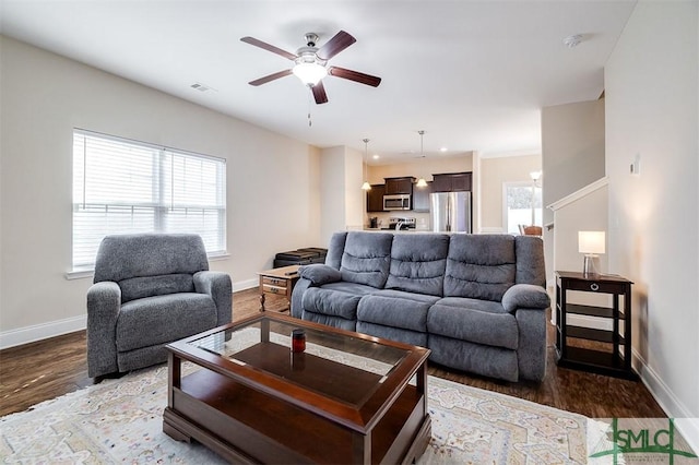 living room with ceiling fan and wood-type flooring