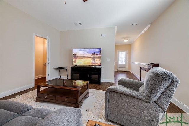 living room featuring hardwood / wood-style flooring and ornamental molding