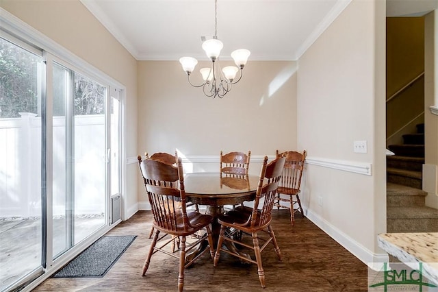 dining room with ornamental molding, a chandelier, and dark hardwood / wood-style flooring