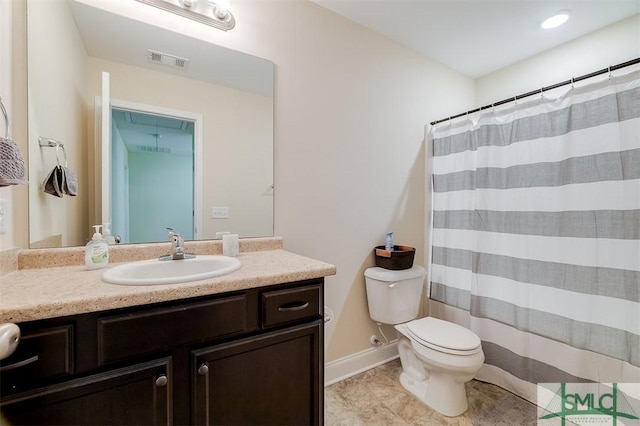 bathroom featuring vanity, toilet, and tile patterned flooring