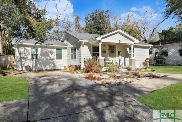 bungalow-style home with a front lawn and covered porch