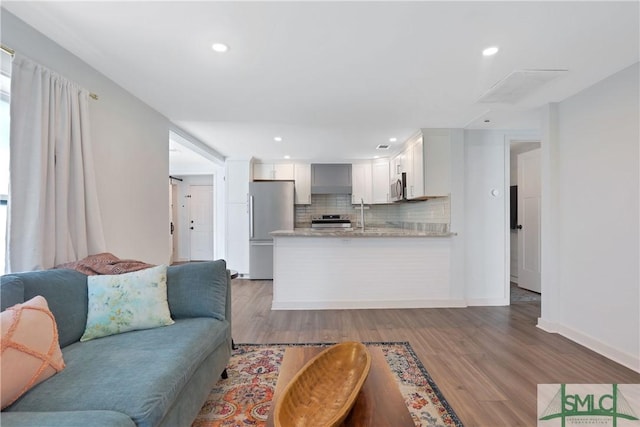 living room with light hardwood / wood-style flooring