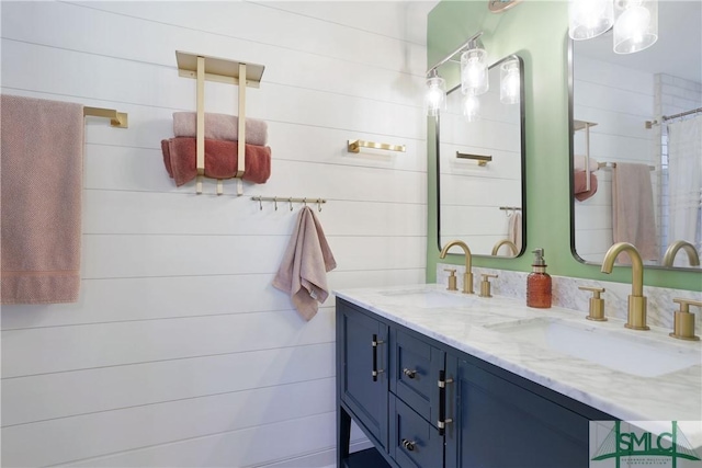 bathroom featuring vanity and wooden walls