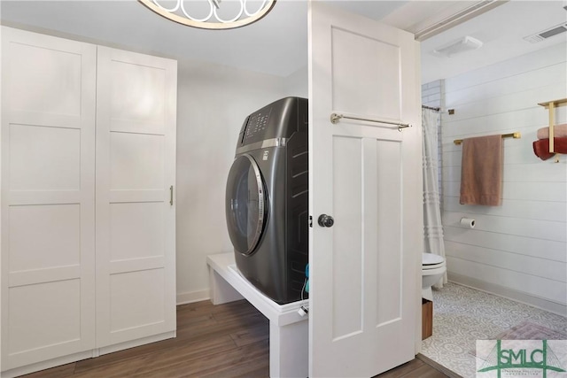 laundry area with washer / dryer and dark hardwood / wood-style flooring