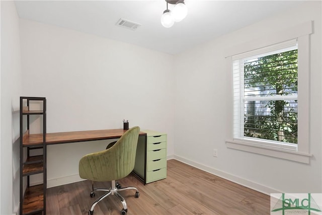 office space with light hardwood / wood-style floors