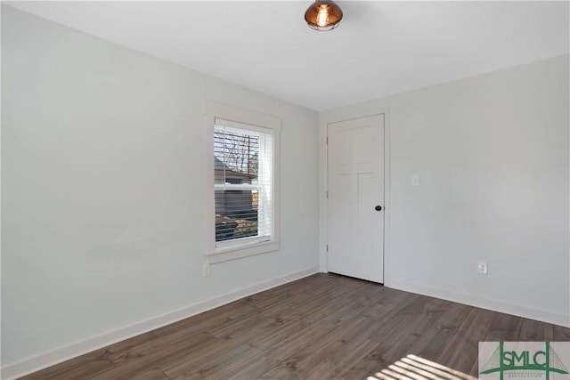 empty room featuring dark hardwood / wood-style flooring