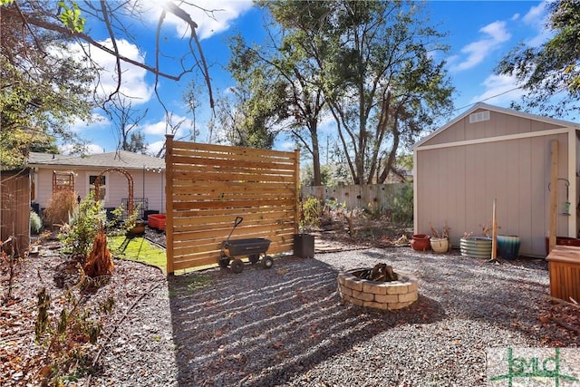 view of patio featuring a storage shed and an outdoor fire pit