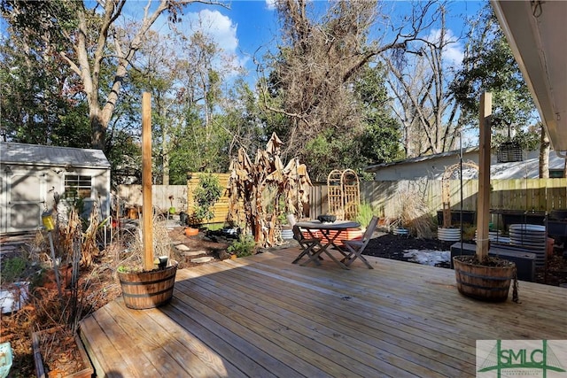 wooden terrace featuring a storage unit