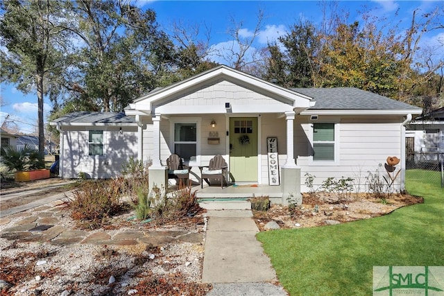 bungalow-style home featuring a front lawn and a porch