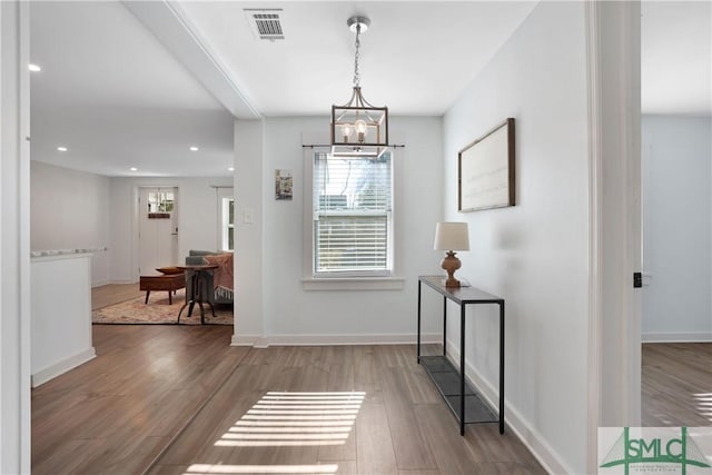 interior space with hardwood / wood-style floors and an inviting chandelier