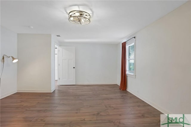 unfurnished room featuring dark wood-type flooring