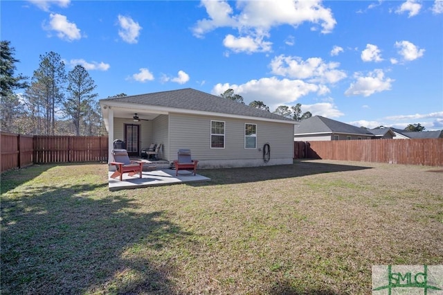 back of property with ceiling fan, a patio, and a lawn