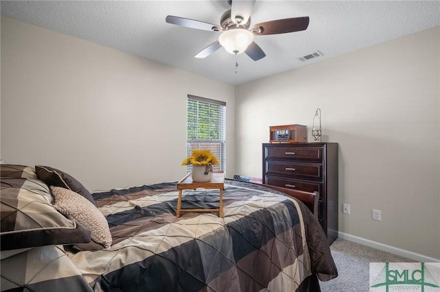 carpeted bedroom featuring a textured ceiling and ceiling fan