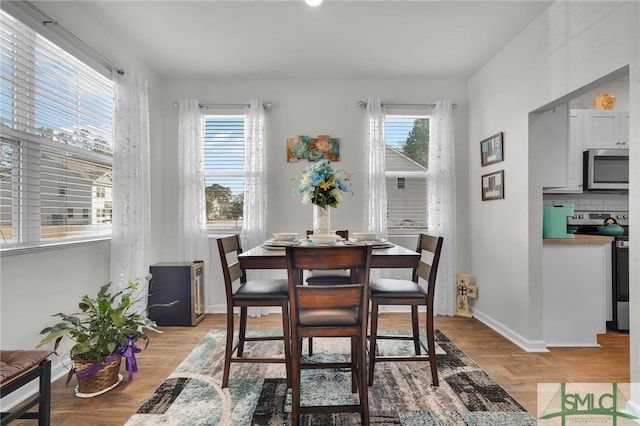 dining space with light wood-type flooring