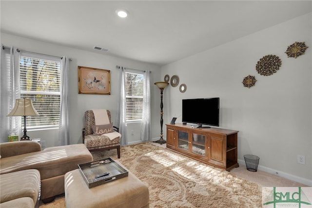 living room with a healthy amount of sunlight and light carpet