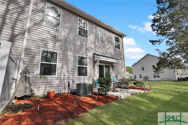 rear view of house featuring central AC, a patio area, and a lawn