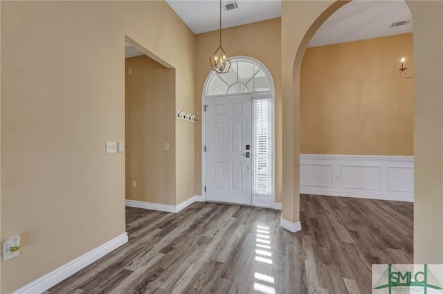 foyer with a chandelier and hardwood / wood-style floors