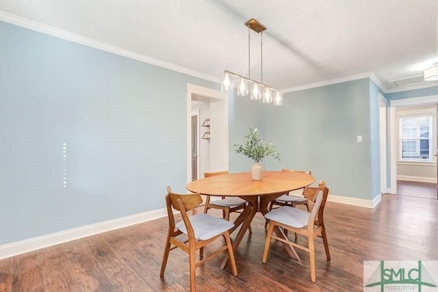 dining space with dark wood-type flooring and ornamental molding