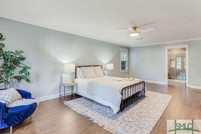 bedroom featuring multiple windows, hardwood / wood-style flooring, and crown molding