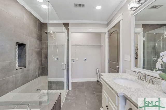 bathroom featuring crown molding, vanity, tile patterned floors, and walk in shower