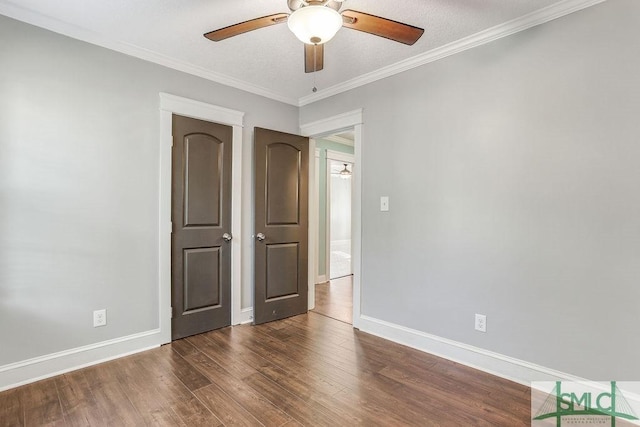 unfurnished bedroom featuring ornamental molding, dark hardwood / wood-style floors, and ceiling fan