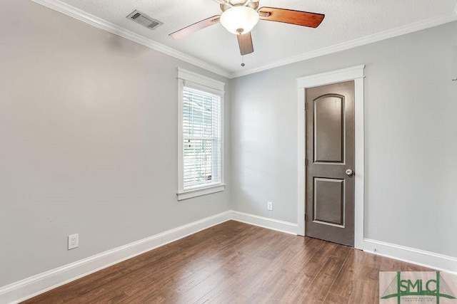 empty room featuring crown molding, dark hardwood / wood-style floors, and ceiling fan