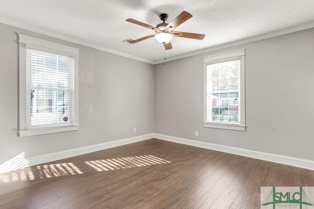 spare room with crown molding, dark wood-type flooring, a textured ceiling, and ceiling fan