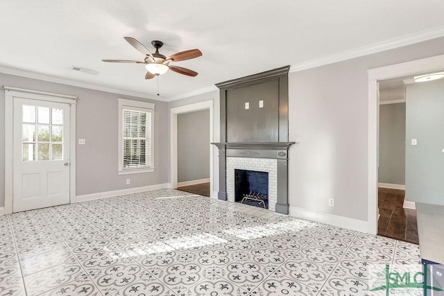 unfurnished living room featuring crown molding, a brick fireplace, and ceiling fan