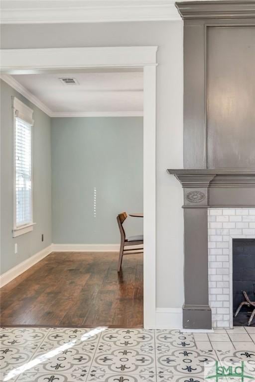 interior space featuring a fireplace, ornamental molding, and wood-type flooring