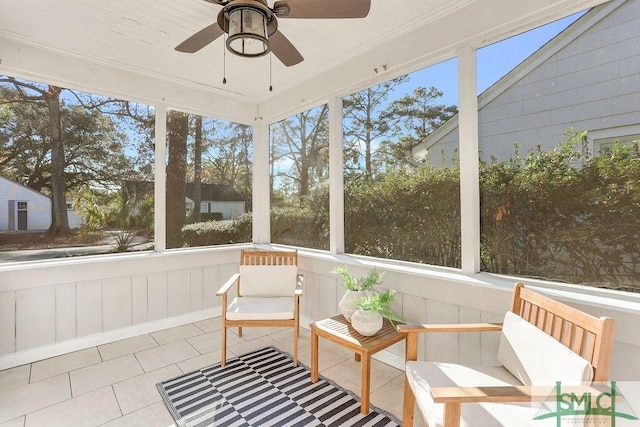 unfurnished sunroom with ceiling fan