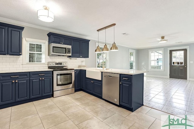 kitchen featuring stainless steel appliances, kitchen peninsula, and blue cabinets