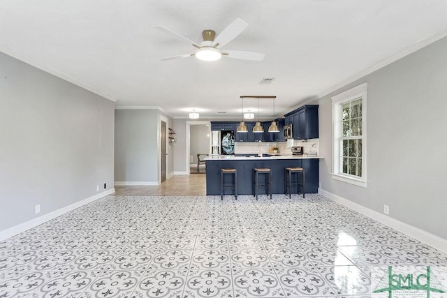 kitchen featuring blue cabinets, backsplash, a kitchen bar, ornamental molding, and kitchen peninsula