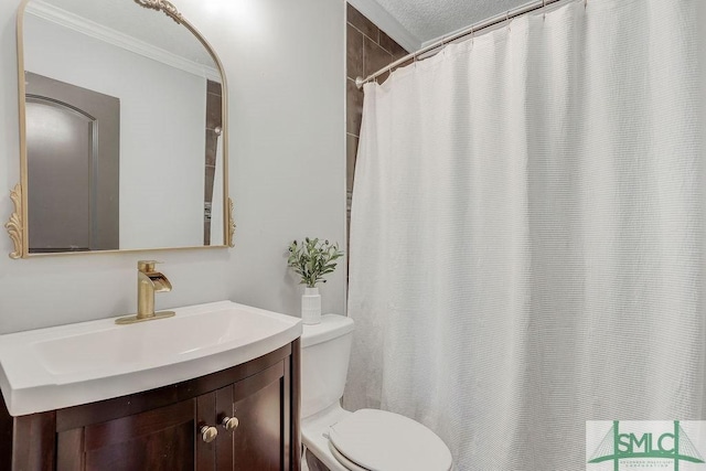 bathroom with crown molding, vanity, and toilet