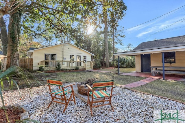 exterior space featuring a wooden deck and a fire pit