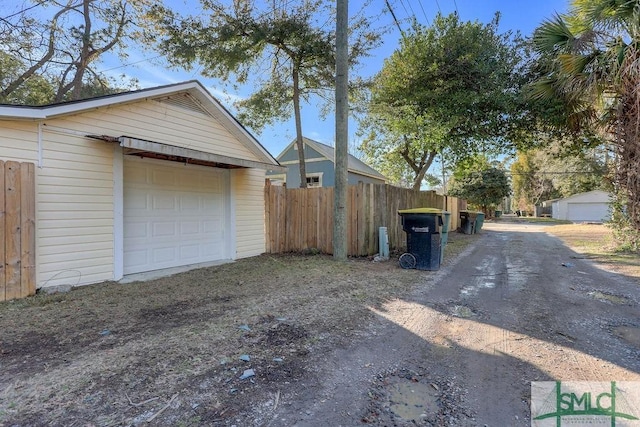 view of property exterior with a garage and an outdoor structure