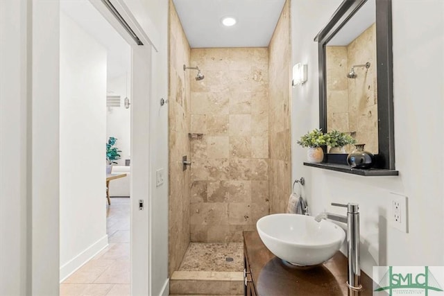 bathroom with vanity, tile patterned floors, and tiled shower