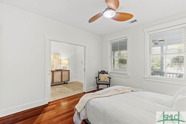 bedroom with ceiling fan and light wood-type flooring