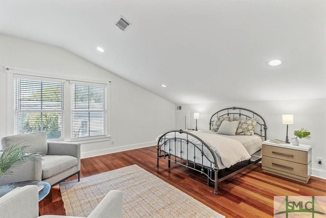 bedroom with dark wood-type flooring and vaulted ceiling