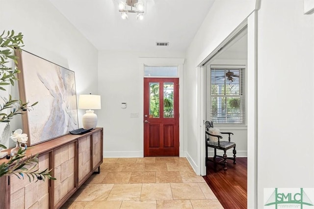 foyer entrance featuring a notable chandelier