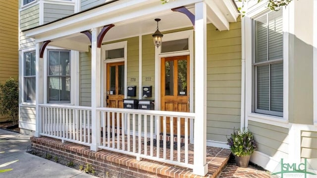 view of exterior entry featuring a porch