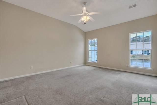 carpeted empty room with ceiling fan and lofted ceiling