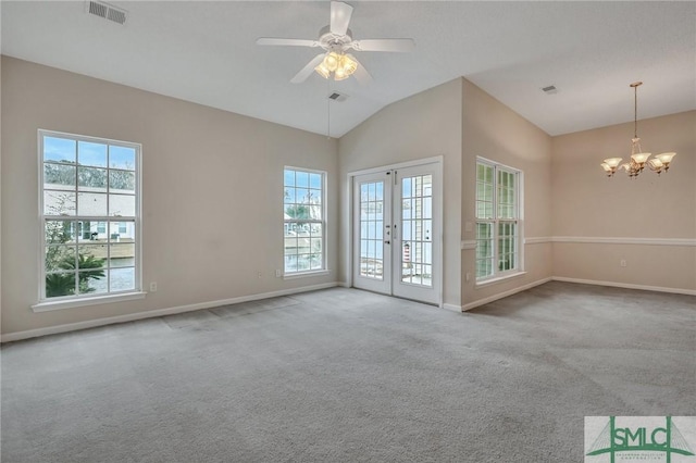 spare room featuring vaulted ceiling, light carpet, and a wealth of natural light